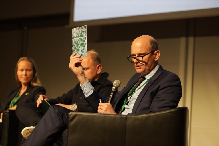 CEO of GH2, Jonas Moberg, holding the Green Hydrogen Standard booklet