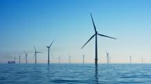 A photograph of several wind turbines, standing in the ocean. Image by Nicholas Doherty.